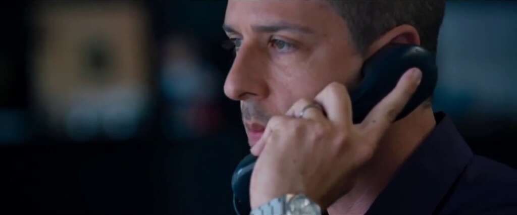 A photo of Vinny answering a phone call. He wears the Rolex Datejust Oysterquartz watch.
